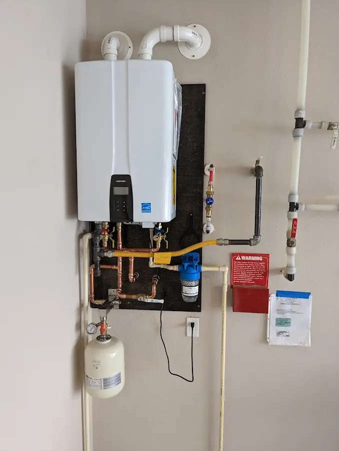 Professional plumber installing copper piping in a Martin home
